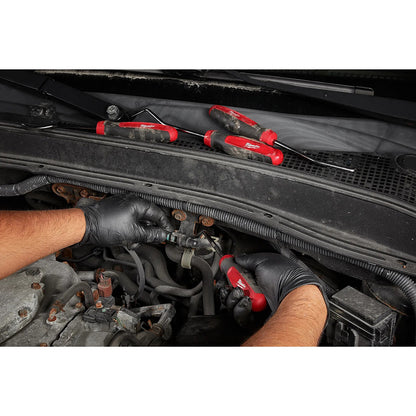 Person working on a car engine with tools, wearing black gloves.