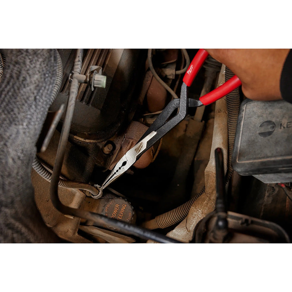 Close-up of a person using pliers on car wiring under the hood.