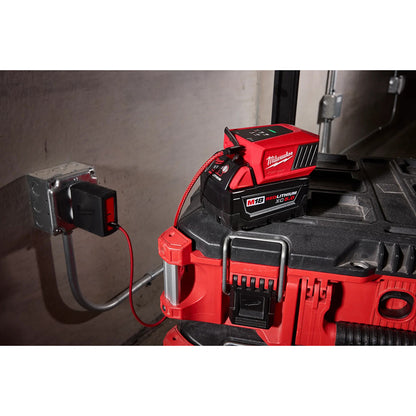 Red Milwaukee power tool with battery pack on a concrete surface