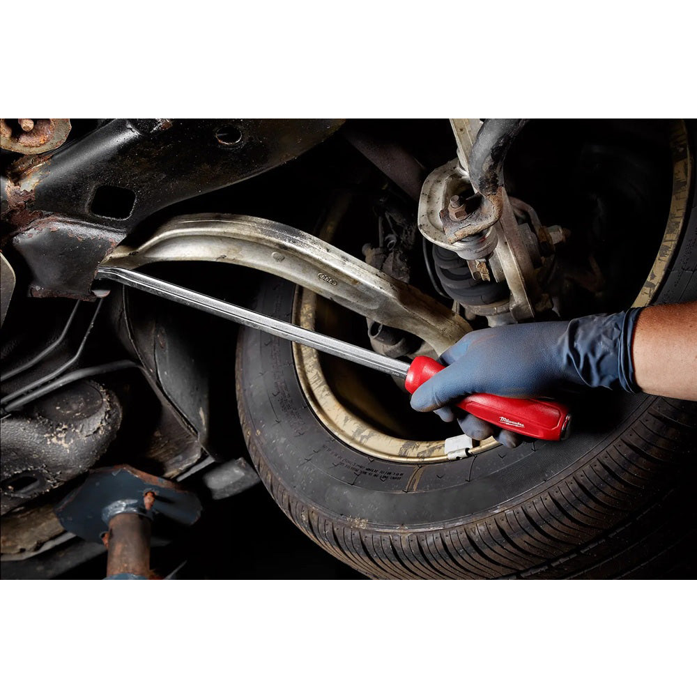 Person working on a car tire with a tool, wearing a blue glove.