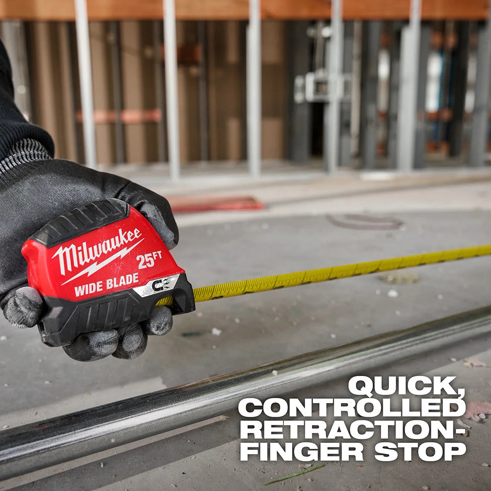 Person holding a Milwaukee tape measure on a construction site
