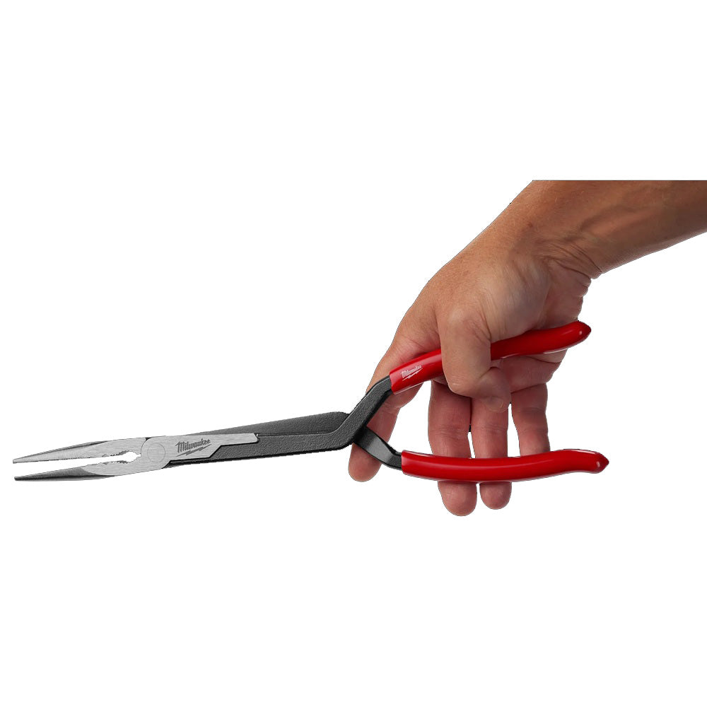 Hand holding a pair of pliers with red handles on a white background