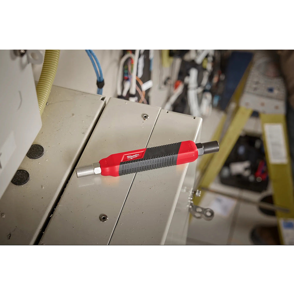 Red and black tool on a metal surface with a workshop background
