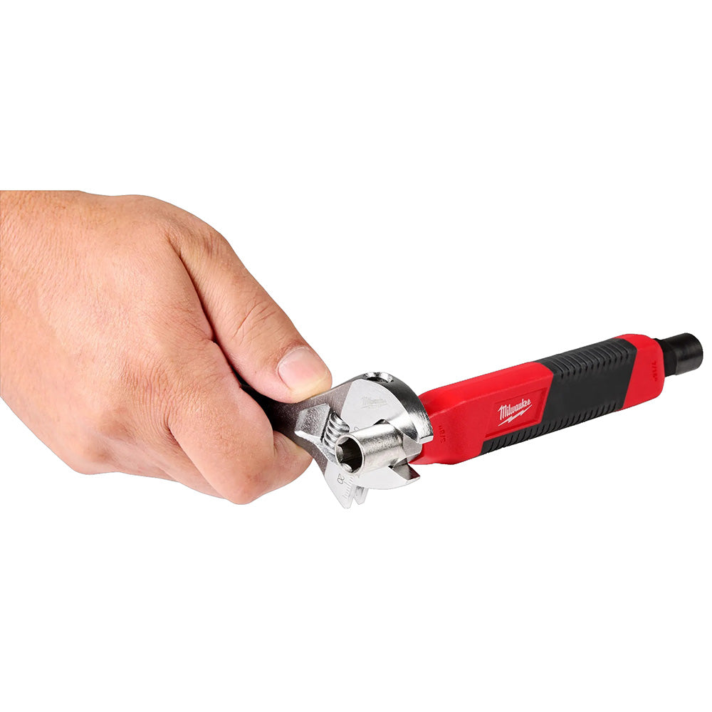 Hand holding a red and black tool with a visible brand logo on a white background