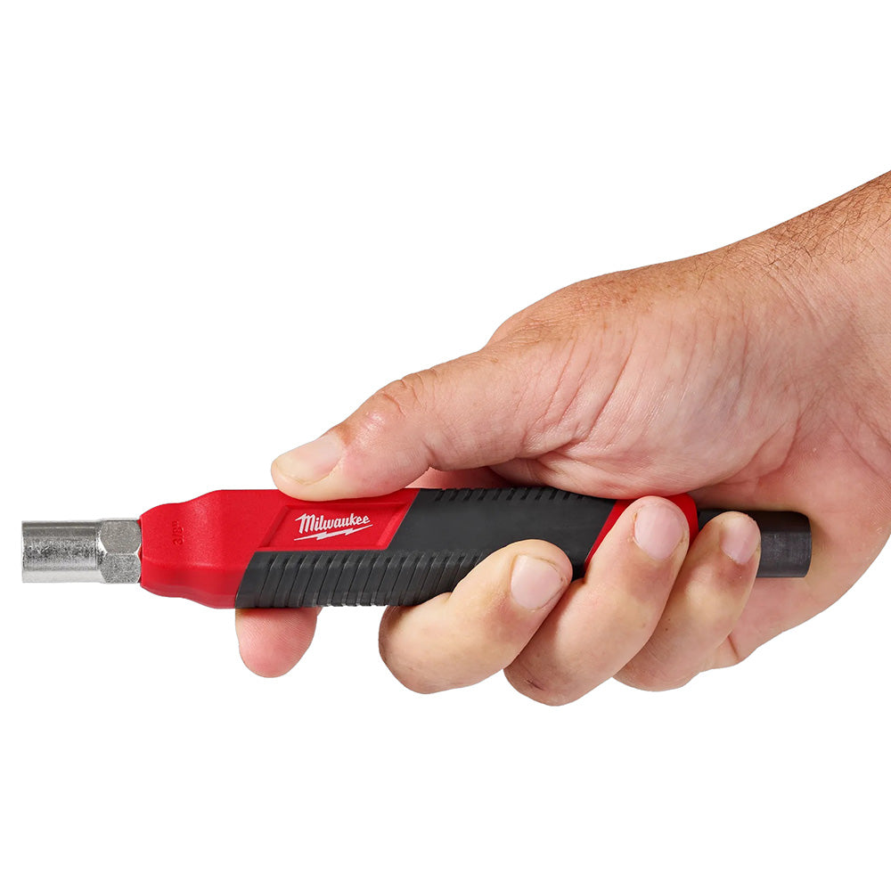 Hand holding a Milwaukee tool with a white background