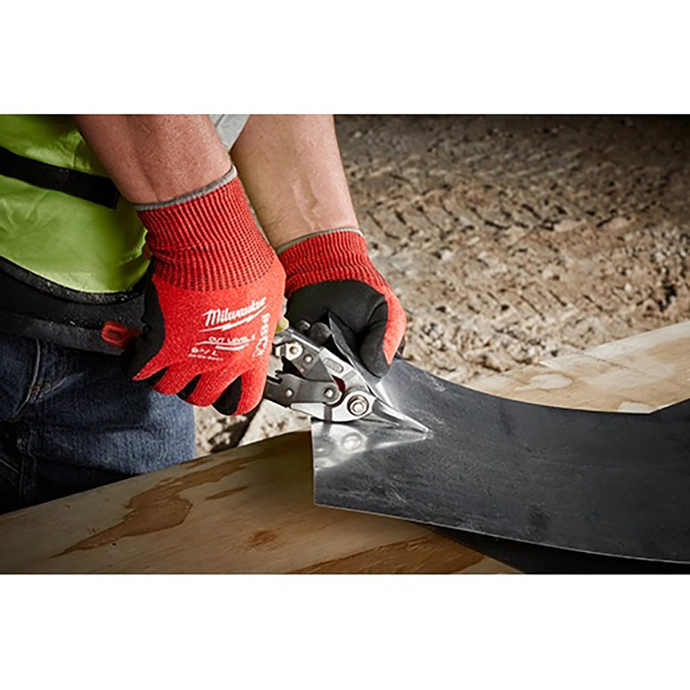 Person using a tool with red gloves on a construction site
