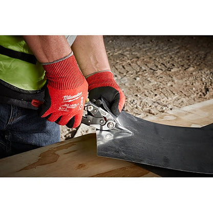 Person using a tool with red gloves on a construction site