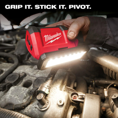 Milwaukee tool being used on a car engine with 'Grip It. Stick It. Pivot.' text above.