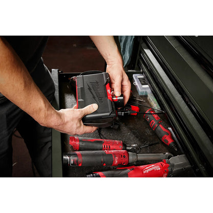 Person organizing red and black power tools in a drawer.