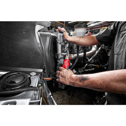 Mechanic working on a vehicle engine with tools