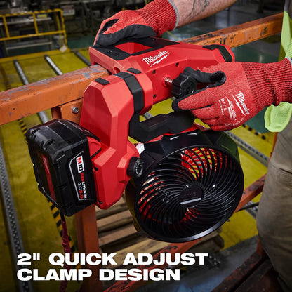 Person using a Milwaukee fan with a 2-inch quick adjust clamp design on a construction site.