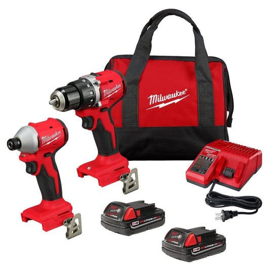 Milwaukee tool kit with drill, impact driver, batteries, and charger on a white background