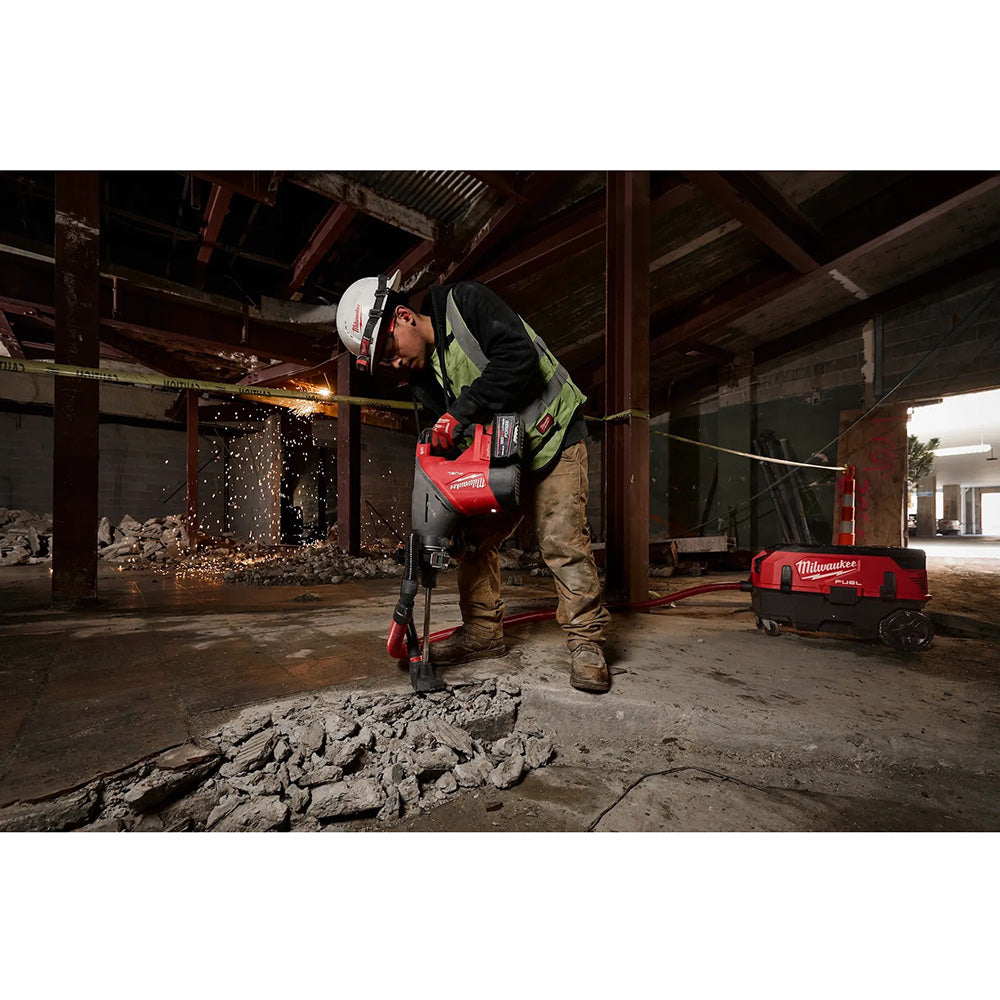 Worker using a circular saw in an industrial setting with visible sparks.