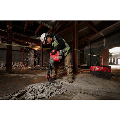 Worker using a circular saw in an industrial setting with visible sparks.