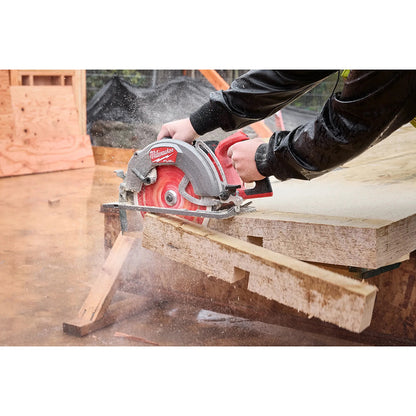 Person using a Milwaukee circular saw to cut wood on a wooden surface.