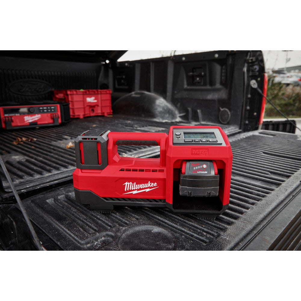 M18™ Inflator tool battery pack on a black truck bed.