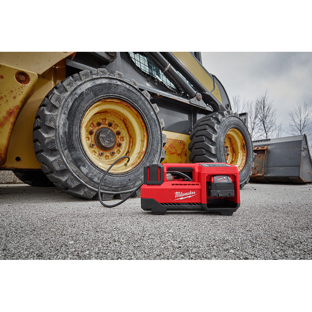 M18™ Inflator on the ground with a skid steer in the background.