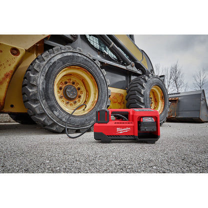 M18™ Inflator on the ground with a skid steer in the background.