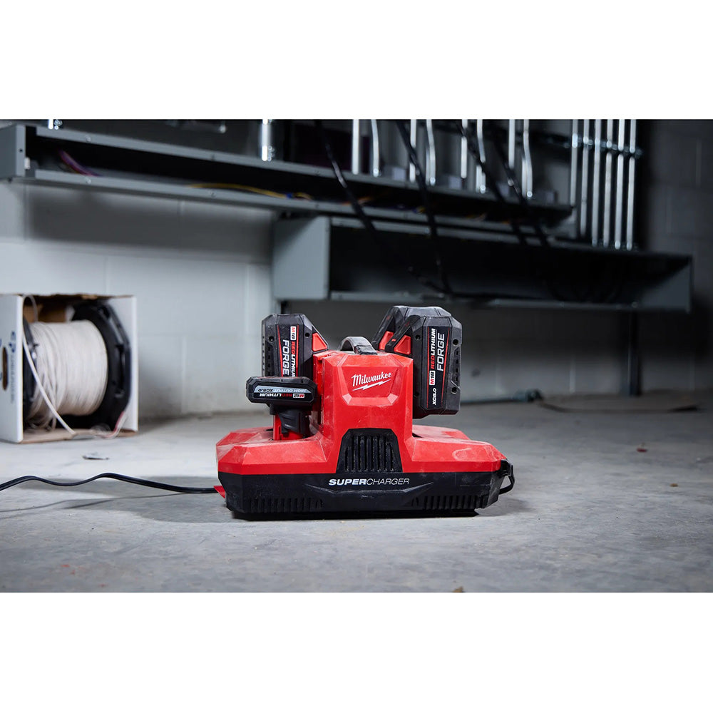 Red Milwaukee Super Charger tool on a concrete floor with a blurred background