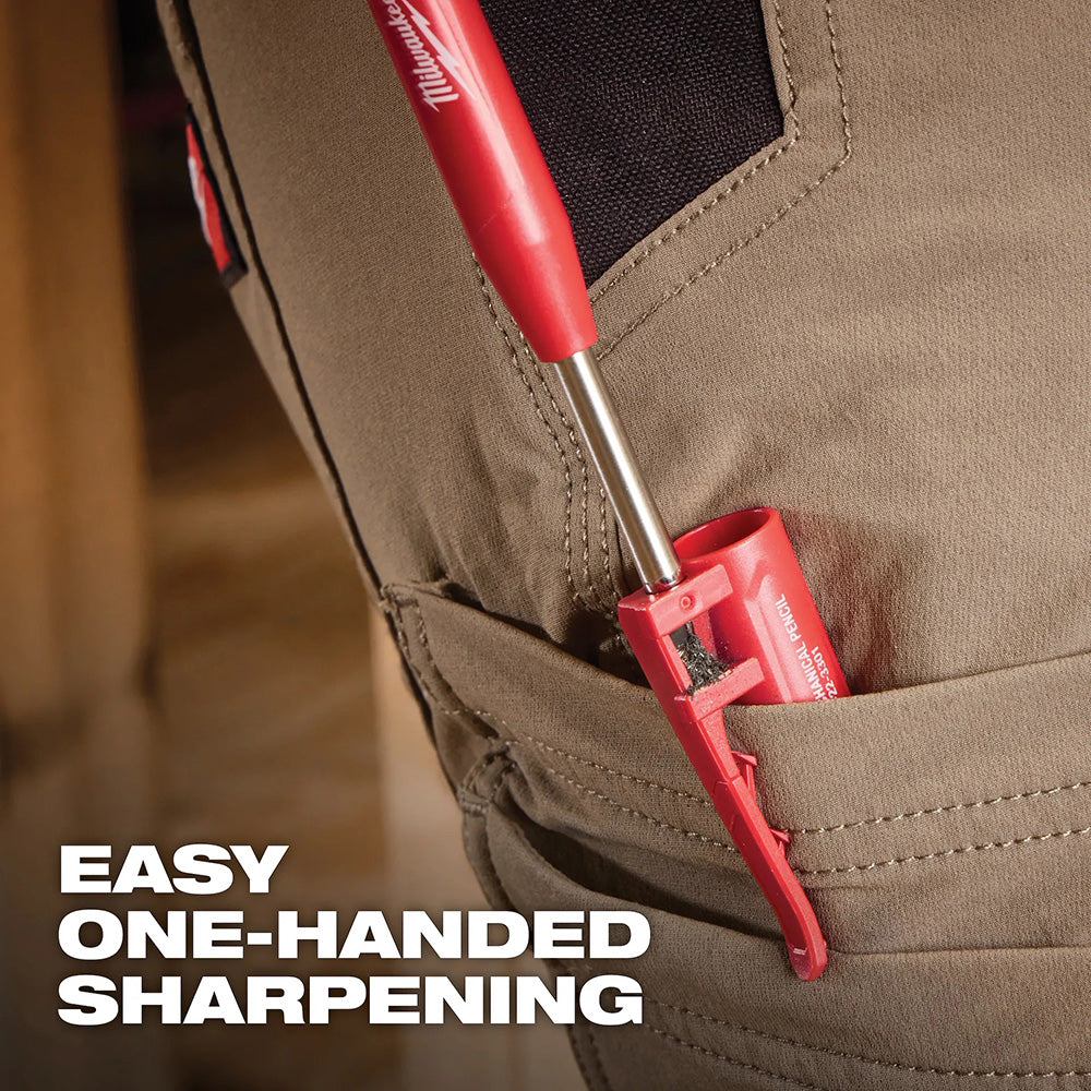 Red Milwaukee mechanic pencil being inserted into a brown pocket with text 'Easy One-Handed Sharpening'.