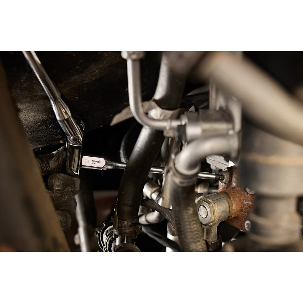 Close-up of mechanical components with a wrench, likely from a vehicle or machinery.