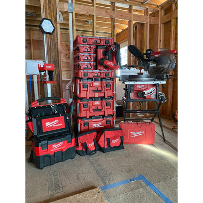 Stack of Milwaukee PACKOUT and tools in a construction setting.