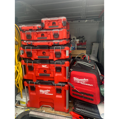 Stack of PACKOUT™ Compact Organizer, boxes and bags in a garage.