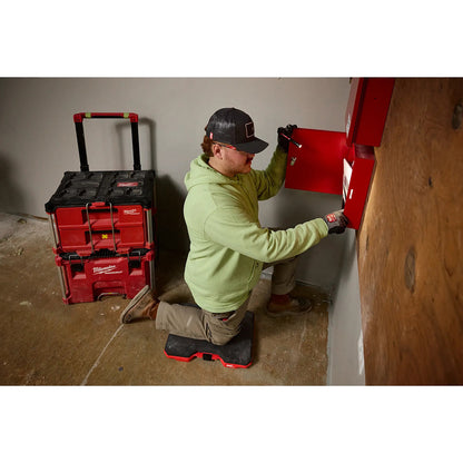 Person using a red tool chest in a home improvement setting