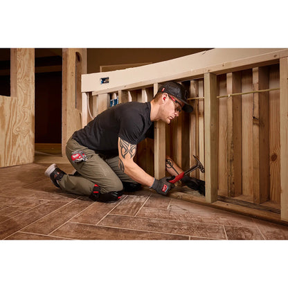 Person working on a wooden structure using a hammer.